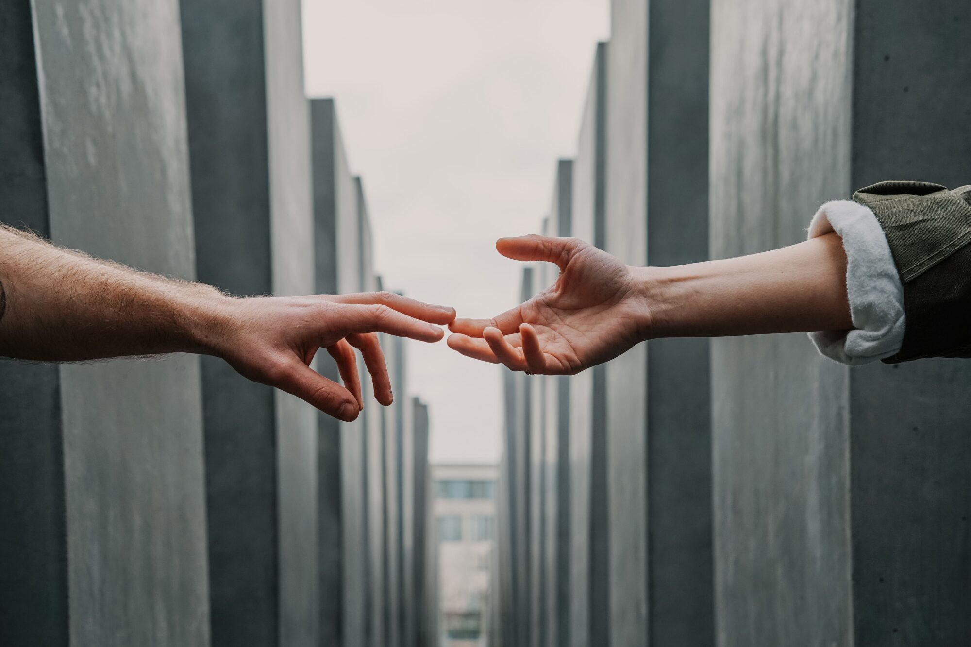 two hands touching each other after they received counselling service from the best psychologist in Bangladesh