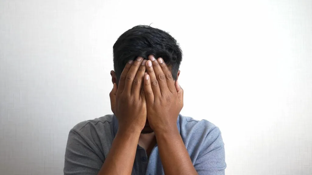Man covering face for depression