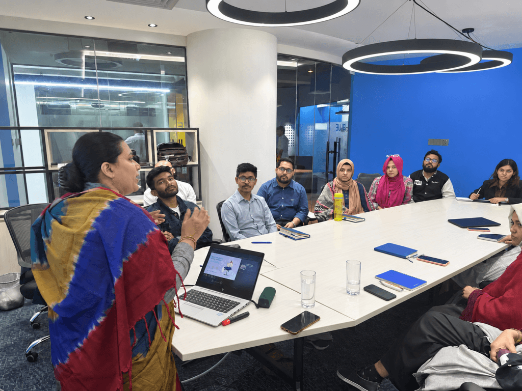 A Chum Wellness clinical psychologist leading a mental-health session with a team in Dhaka