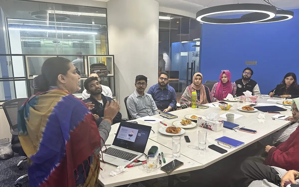 A Chum Wellness clinical psychologist leading a mental-health session with a team in Dhaka