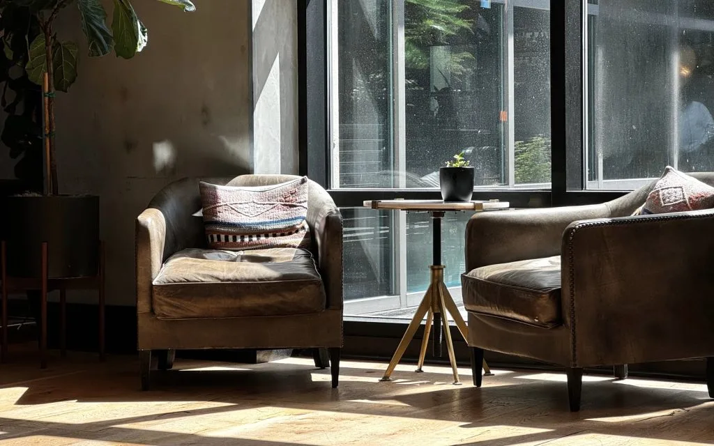 A quiet, sunlit counselling room with two armchairs